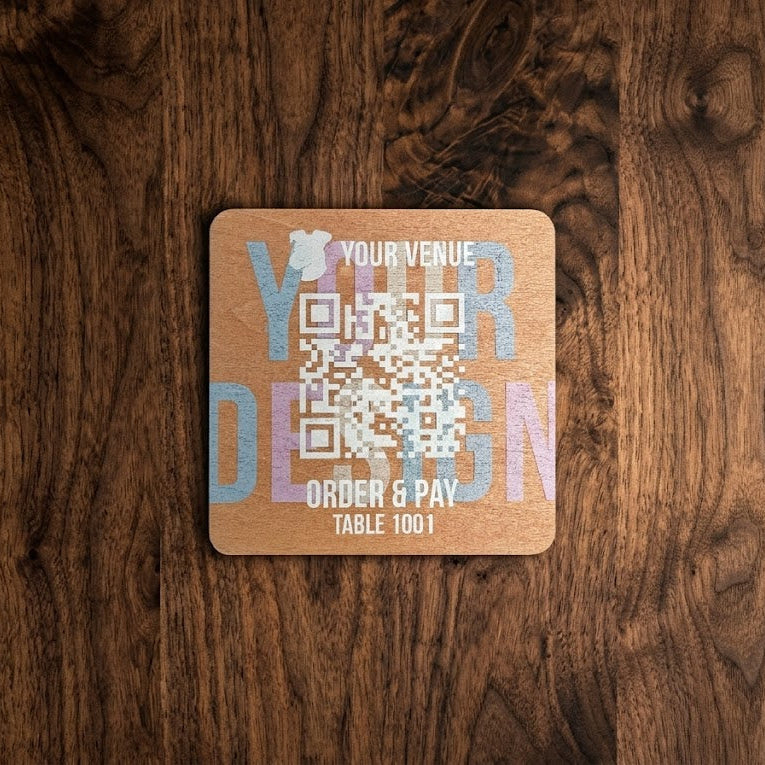 Tile with QR code and text on a wooden surface